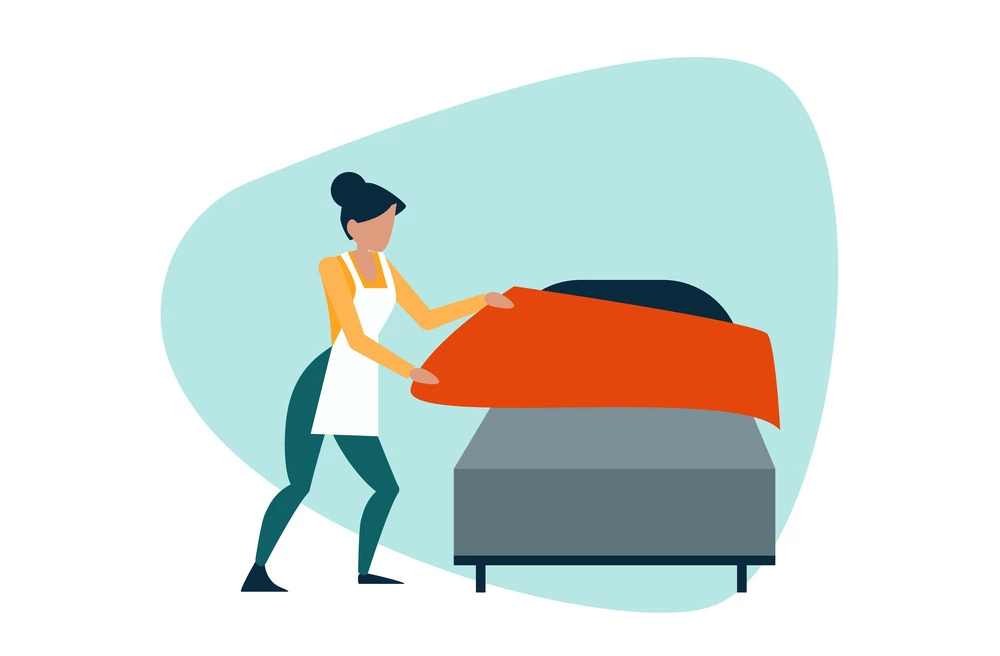 housekeeper making the bed