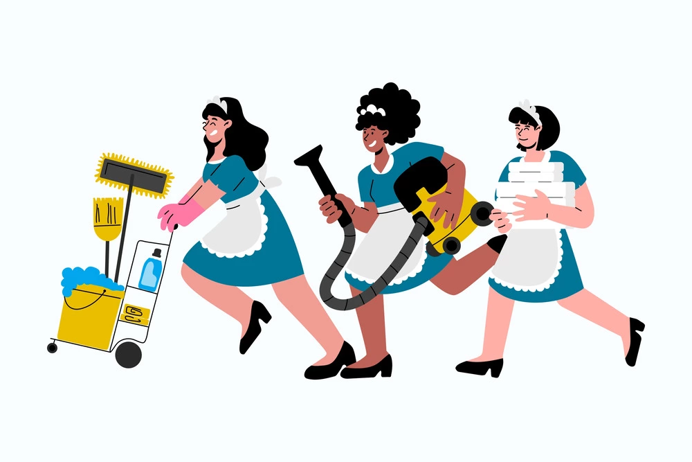 three housekeepers carrying cleaning supplies