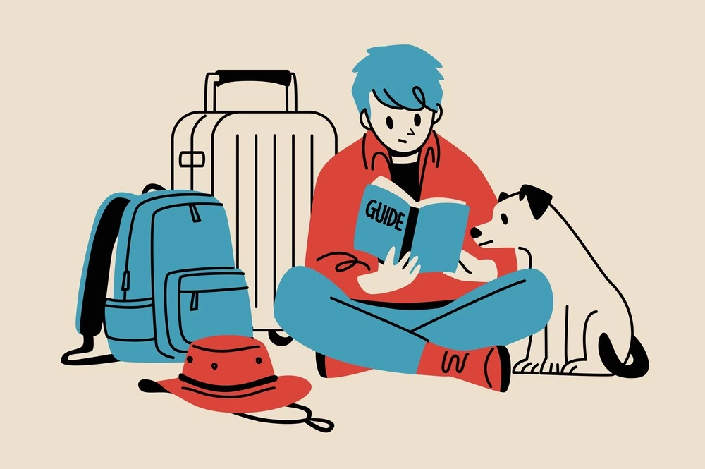man and dog looking at travel guide